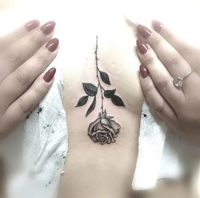 Upside Down Rose In Between Boobs Tattoo Design 