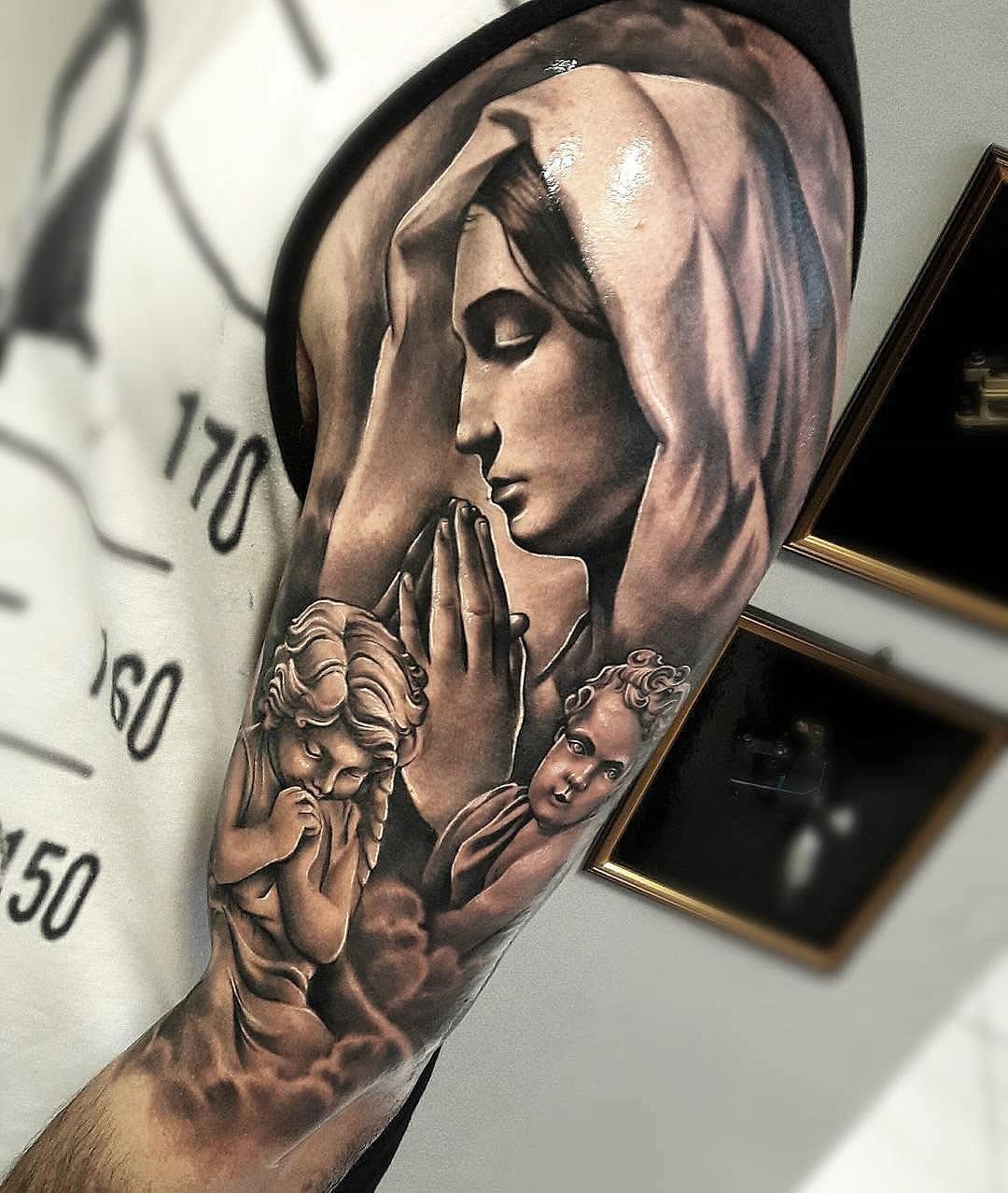 Tattoo of praying hands with the Virgin Mary