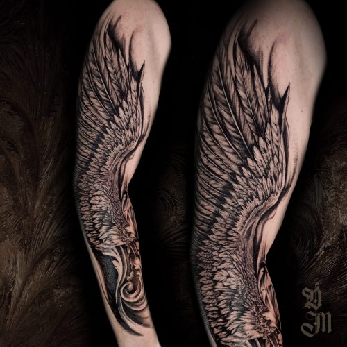 Full-sleeve tattoo of angel wings in black ink