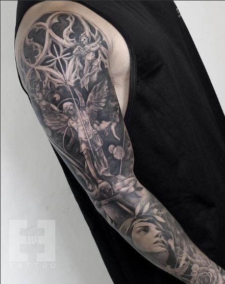 Full-sleeve tattoo of religious symbols and angels