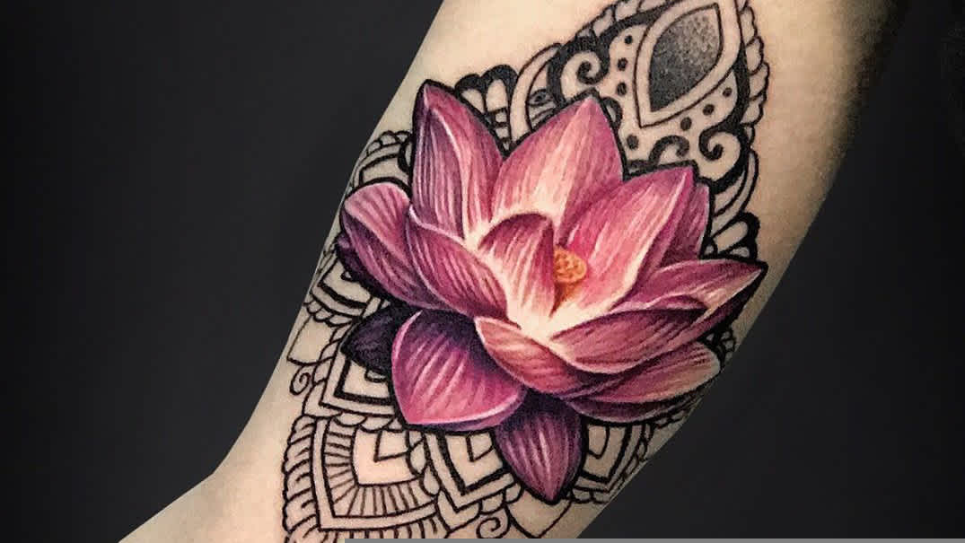 Colorful lotus flower tattoo on sleeve