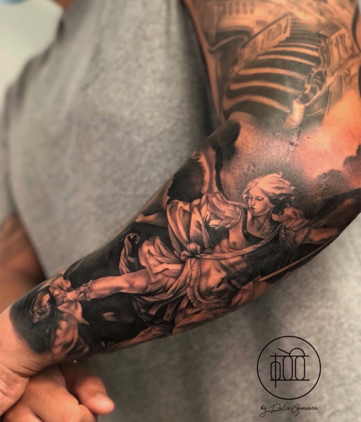 Full-sleeve St. Michael tattoo with black ink